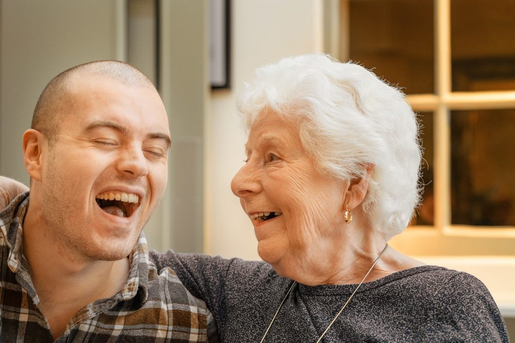 Photo of an elder and a laughing young man.